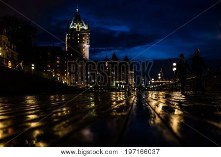 Quebec City Canada - May 30 2017: Old town closeup view of wet dufferin terrace at night with Chateau Frontenac