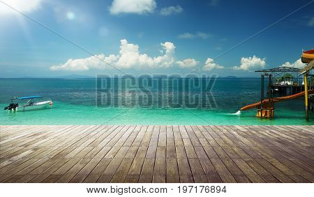 Empty wood jetty floor in front of beautiful afternoon seascape .