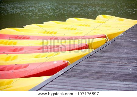 Group of red yellow color Kayak stop at the port
