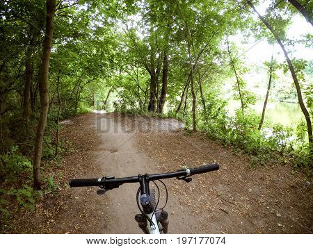 A bicycle stands on a dirt path in the forest. The concept of tourism, recreation. Copy space.