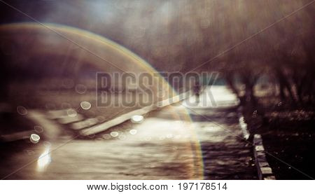 Blurred abstract nature background. Summer defocused view with swirly bokeh and sunbeam