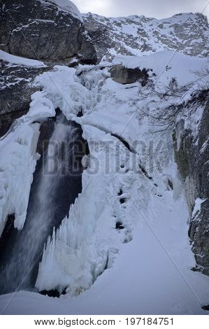 small waterfall in formazza valley during winter