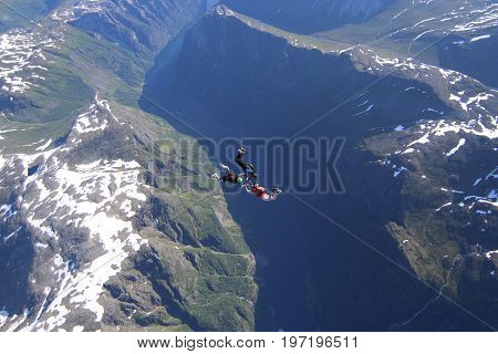 Skydiving over beautiful Norway. Clouds, sun and sky