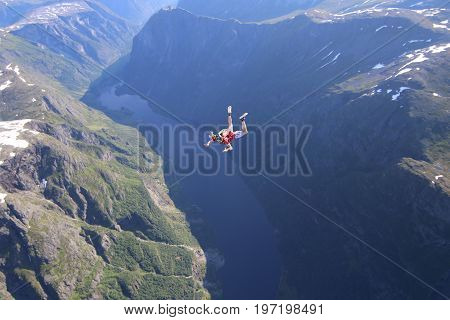 Skydiving over beautiful Norway. Clouds, sun and sky