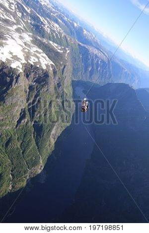 Skydiving over beautiful Norway. Clouds, sun and sky