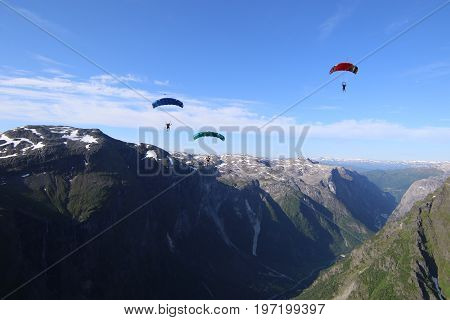 Skydiving over beautiful Norway. Clouds, sun and sky