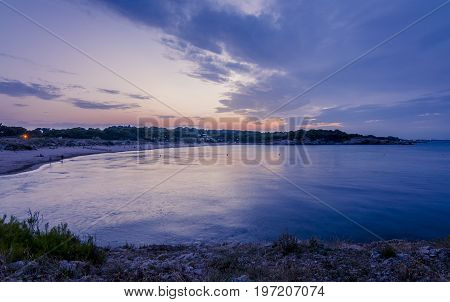 Sunset or blue hour in quiet beach of l'Escala, Costa Brava, Spain. Mediterranean Sea