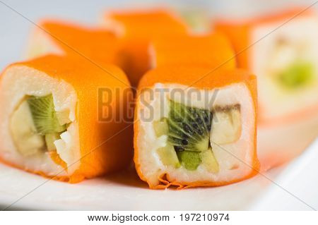 Dessert Maki Sushi - Roll With Various Fruit In Rice Pudding And Coconut Flakes