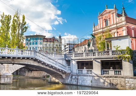 Romantic Ljubljana's city center: river Ljubljanica, Triple Bridge, Tromostovje, Preseren square and Franciscan Church of the Annunciation. Ljubljana, Slovenia, Europe.