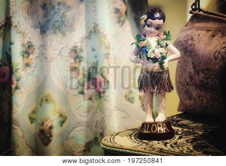 Little Betty Boop style Aloha doll inside a store window in Hawaii with copy space.