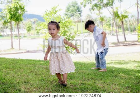 Happy child blowing soap bubbles in spring park with lens flares