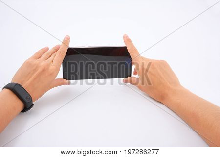 Fitness Bracelet And Phone In Female Hands On White