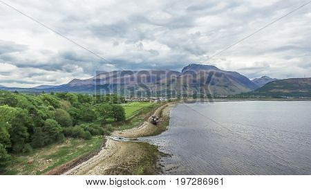 Aerial view of the abandoned ship wreck in Fort William with Ben Nevis in the background, Scotland, United Kingdom