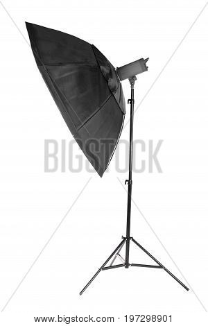 A modern electric saturated black octobox on a tripod. A huge octobox isolated over the white background. Equipment for photogrphers. Professional shooting in a photostudio.
