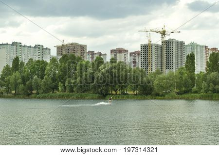 A girl with a beautiful figure is engaged in wakeboarding