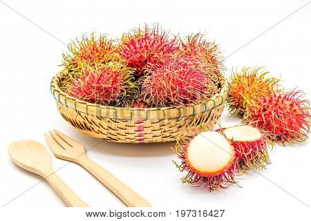 fresh tropical rambutan fruits over basket with spoon and fork on a white background fruit in Thailand