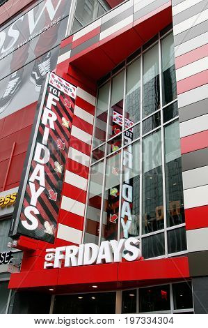 New York July 27 2017: Big sign at the entrance to a TGI Fridays restaurant in Manhattan.