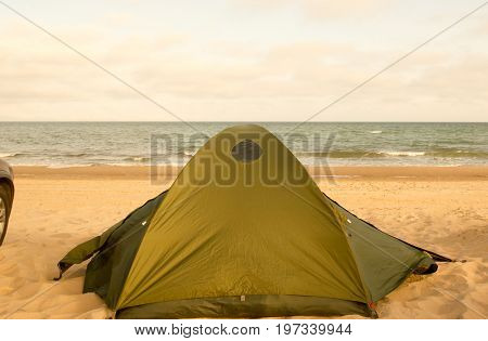 Camping tent and car at seaside daytime