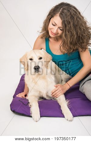 Cute golden retriever dog kissing a woman - isolated over a white background. Dogs and woman friendship