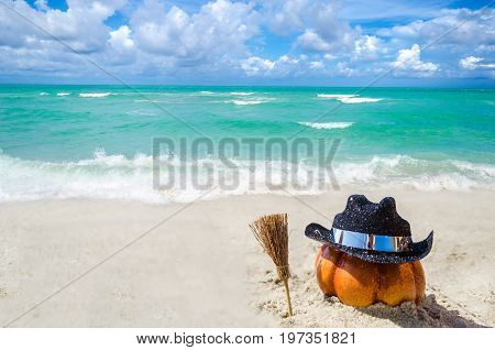 Halloween pumpkin background on the sandy beach near the ocean
