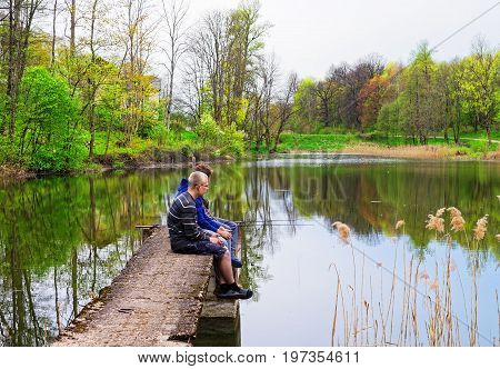 Young Fishermen At Pond In Vilnius Baltic