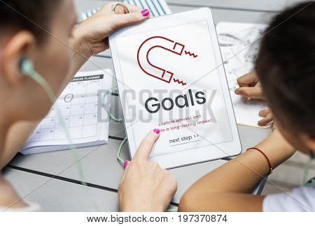 Women working on digital device network graphic overlay
