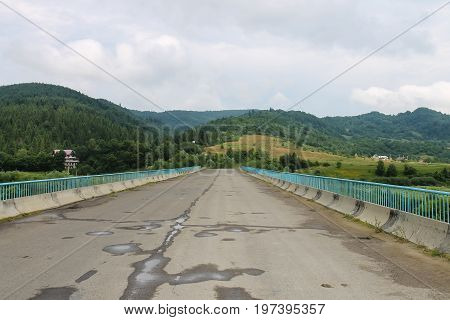 Road between Carpathian hills after light rain. Ukraine