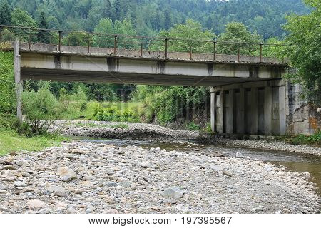 Automobile bridge over small river in the Carpathians Ukraine