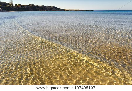 Summer seascape,Apulia coast: Marina di Pulsano beach (Taranto). The coastline is characterized by a alternation of sandy coves and jagged cliffs overlooking a truly clear and crystalline sea.