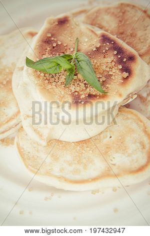 Pancakes with apples decorated with mint and brown sugar