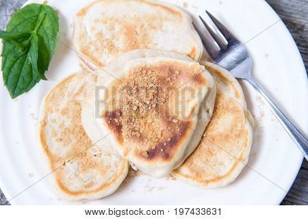 Pancakes with apples decorated with mint and brown sugar