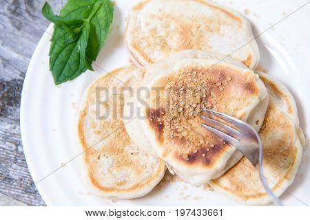 Pancakes With Apples Decorated With Mint And Brown Sugar