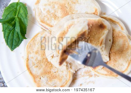 Pancakes with apples decorated with mint and brown sugar