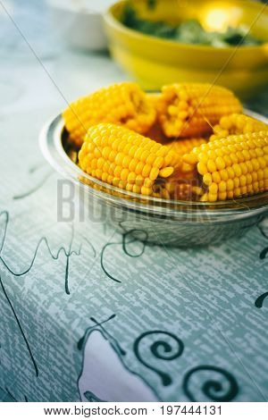 Plateful of fresh sweet organic corn steamed ready to eat. Prepared cooked sweet corn on the table