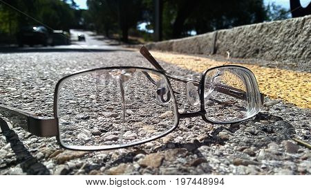 Broken glasses left on the road on a sunny summer day