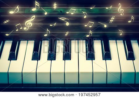 Closeup keyboard of piano with music notes musical instrument