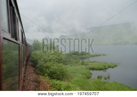 steam from the train in scotland with Highlands in background
