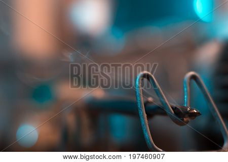 Old soldering iron in instrumental with blurred background