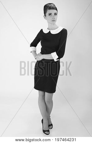 beautiful young woman in retro style with her hair in little black dress