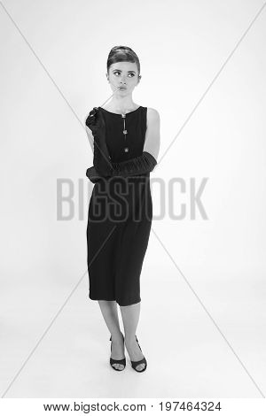 beautiful young woman in retro style with her hair in little black dress