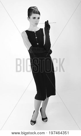 beautiful young woman in retro style with her hair in little black dress