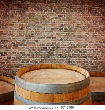 Wooden wine barrel over brick walll background. Oktoberfest concept
