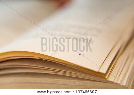 Open old book. Yellowed pages. Page number 271. Paper texture. Macro.