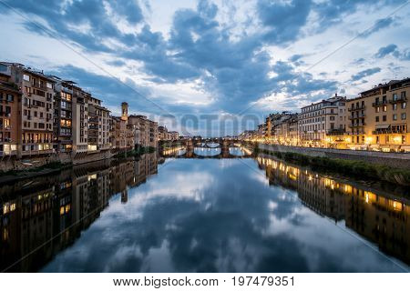 View of the Bridge and Building along Arno river in Florence Italy. At night.