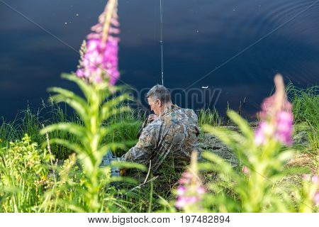 The fisherman catches a pike for spinning off the bank of the channel