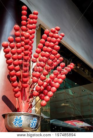 Shanghai, China - Nov 6, 2016: Replicas of tanghulu candies made of wood displayed beside a shop. These 