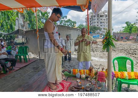 HOWRAH WEST BANGALINDIA - JULY 7TH 2017 : khutipuja the starting ritual of world famous Durga Puja (most famous festival of Hinduism) is being performed by a Hindu Priest amongst Hindu devotees.