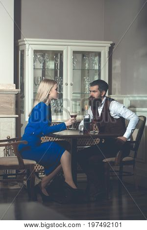 Man And Woman With Blond Hair Sitting With Martini Glasses
