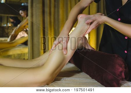 Woman having face massage treatment in wellness center.