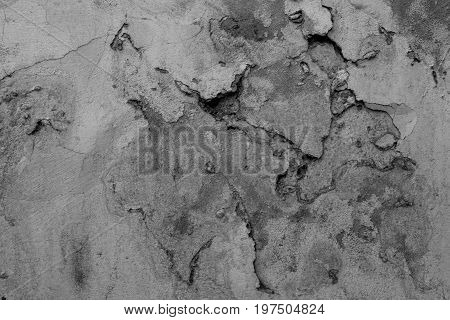 Wall texture with peeling paint. Black and white grunge background.